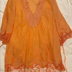 Orange/peach tunic or bathing suit coverup.